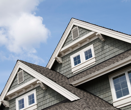 The roof of a house with a blue sky in the background