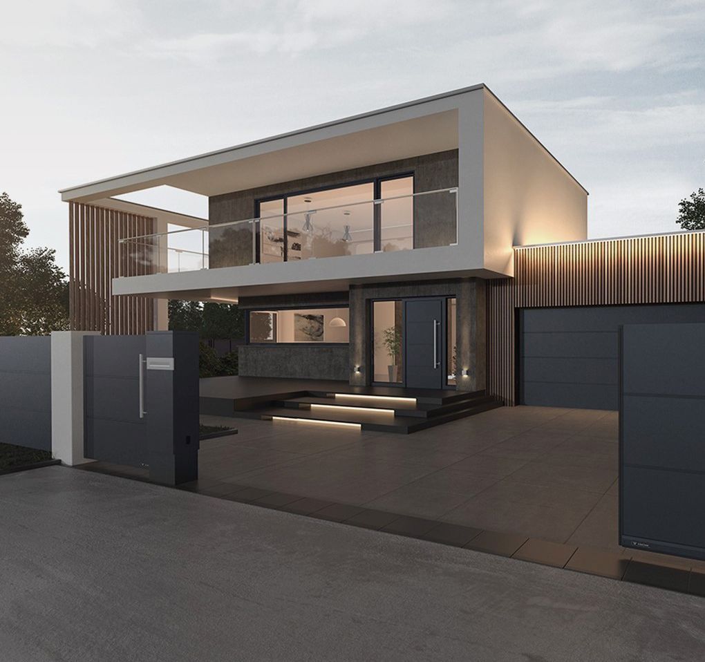 Una casa moderna a due piani con tetto piano, ampie finestre, rivestimento esterno grigio scuro e un vialetto d'ingresso illuminato dietro un cancello.