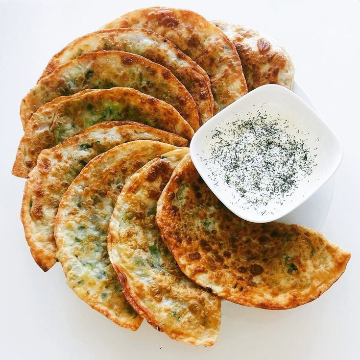 A plate of food with a bowl of dipping sauce