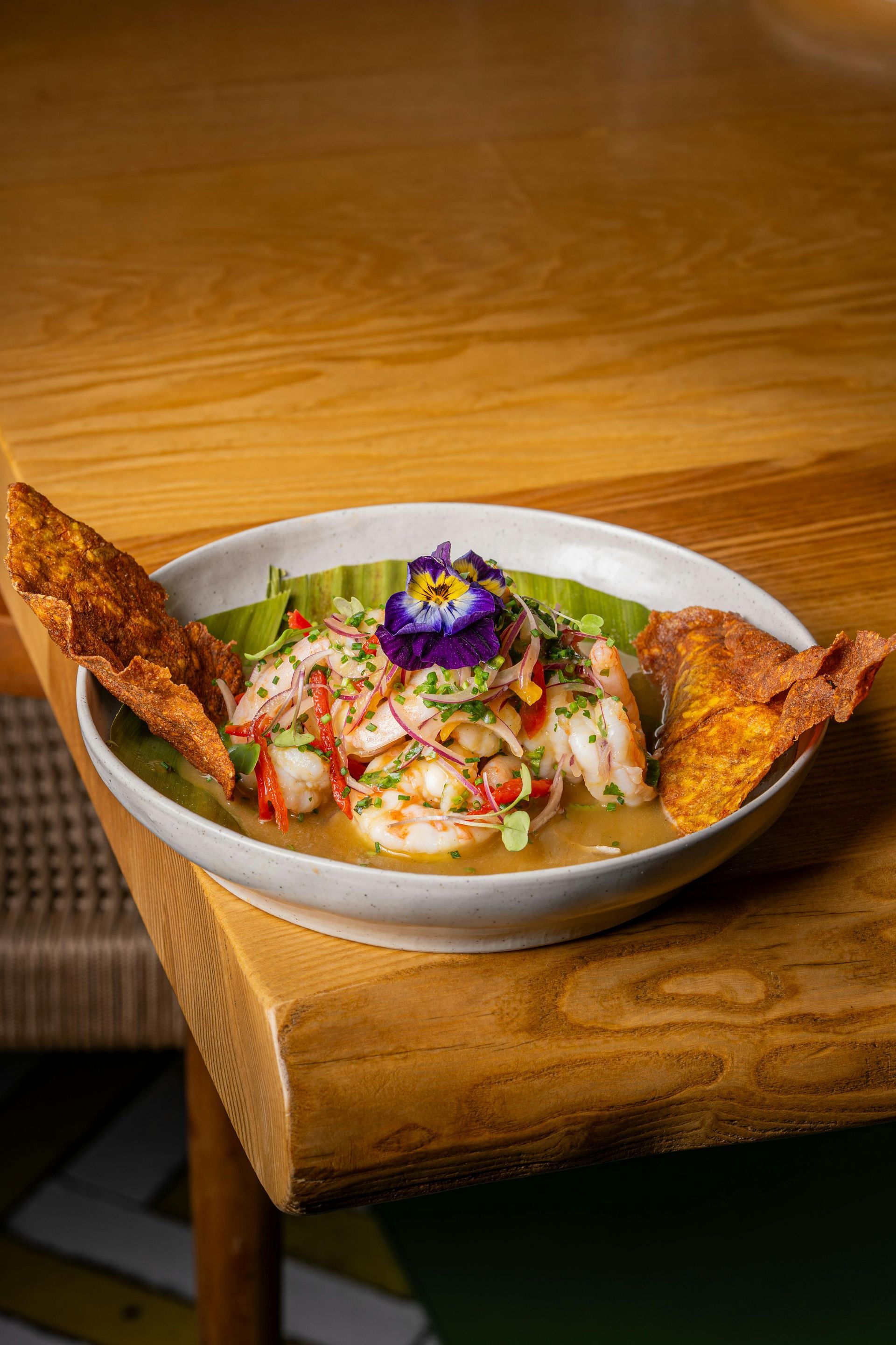 A plate of food is sitting on a wooden table.