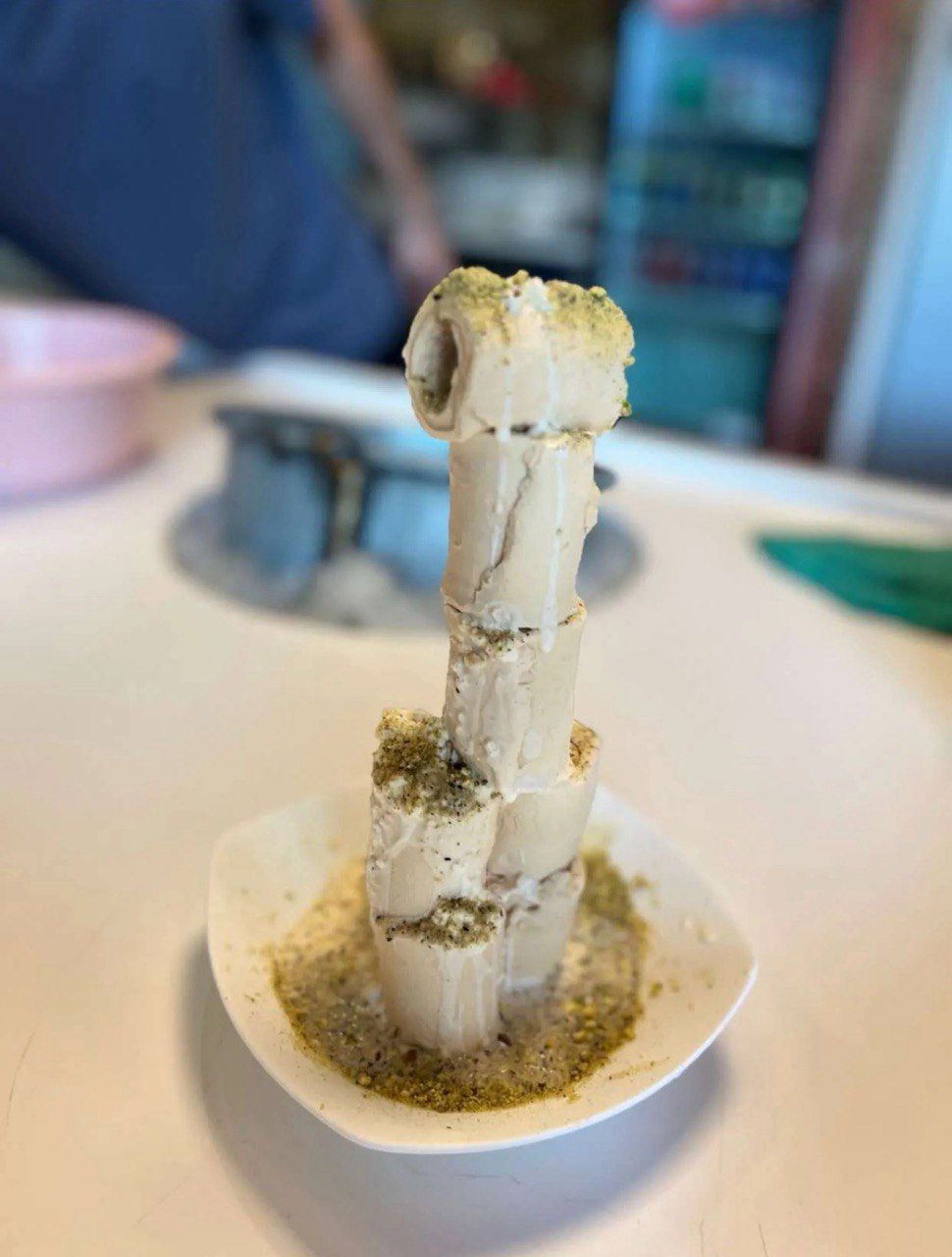 A close up of a bowl of ice cream on a table.