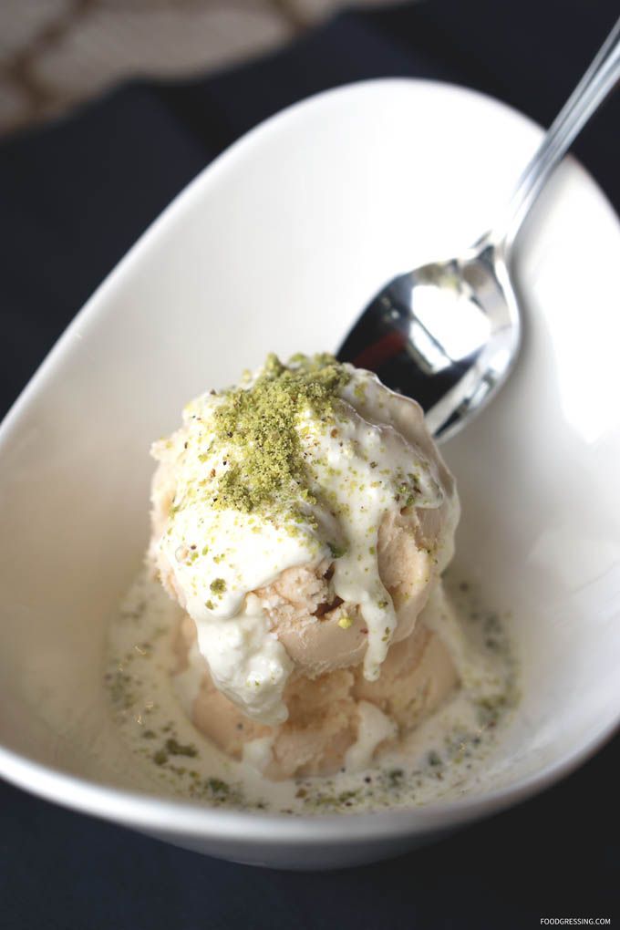 A traditional afghan dessert called sheeryakh served in a bowl at temorian restaurant , topped with crushed pistachios and drizzled with rosewater syrup A traditional afghan dessert called sheeryakh served in a bowl at temorian restaurant , topped with crushed pistachios and drizzled with rosewater syrup