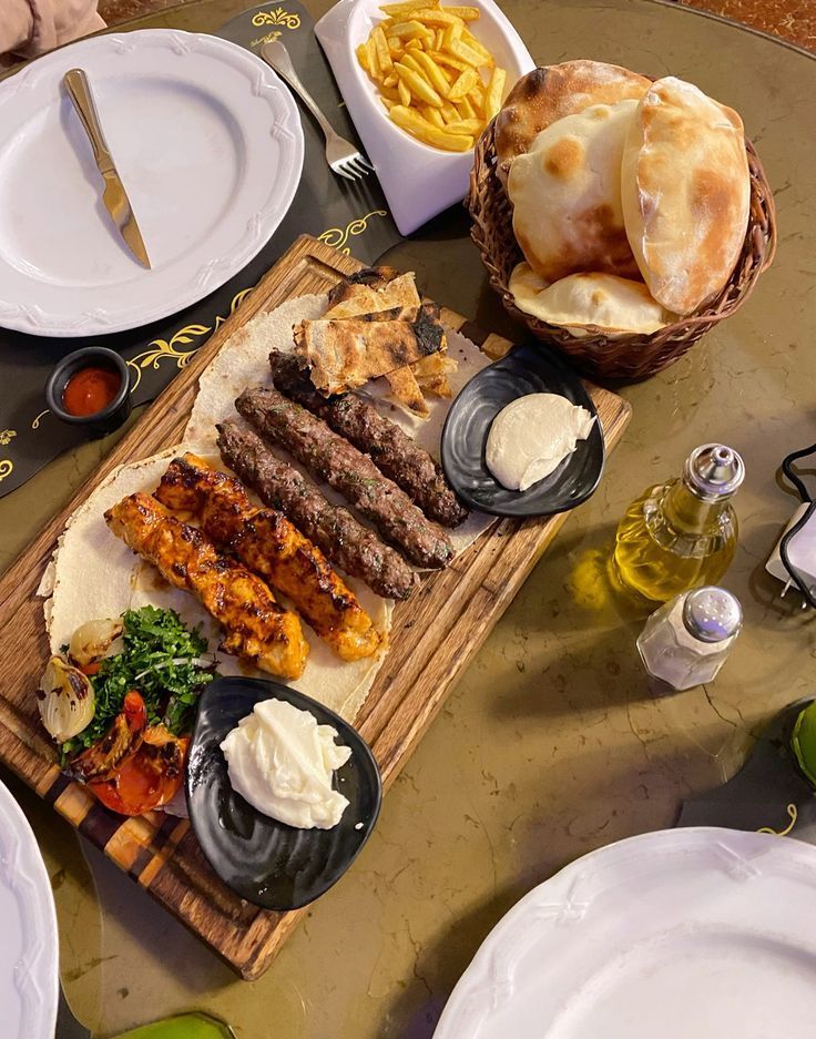 A traditional temorian restaurant table set with colorful Afghan kebabs on a wooden platter 