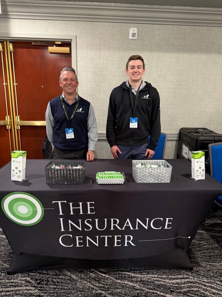 Two people stand behind a black 