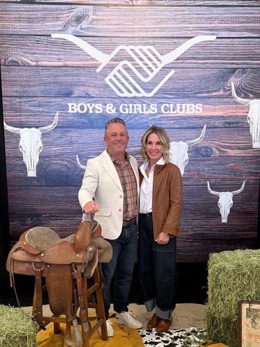High-angle view of a diverse team in a bright office, smiling and holding thumbs up to the camera.