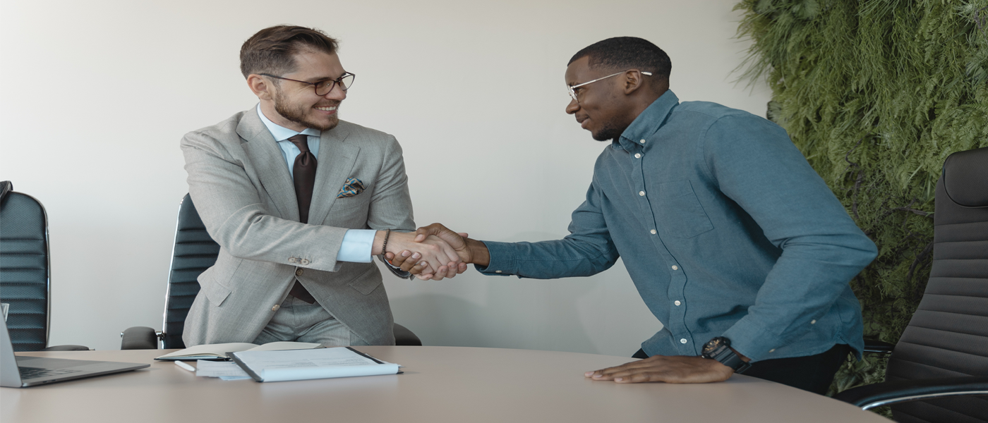Two male people shaking hands
