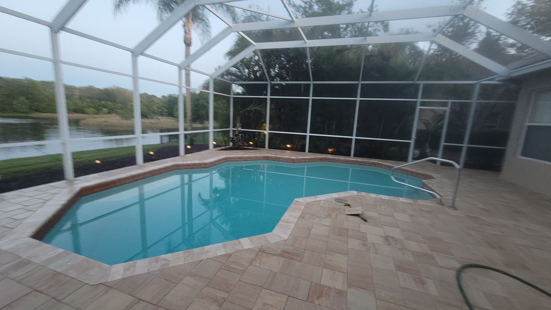 Flagstone - Victory in Cream/Beige with Ivory travertine coping. Brick paver pool deck in Tampa, FL