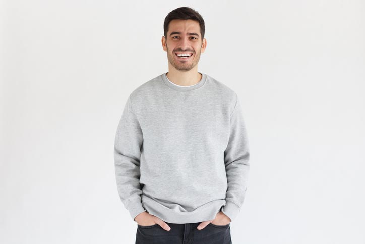 Daylight portrait of young man, wearing oversized sweatshirt
