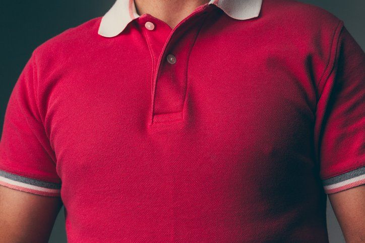 Adult male wearing a red polo shirt