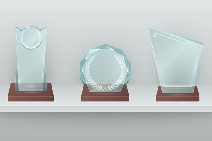 Three crystal awards on shelf