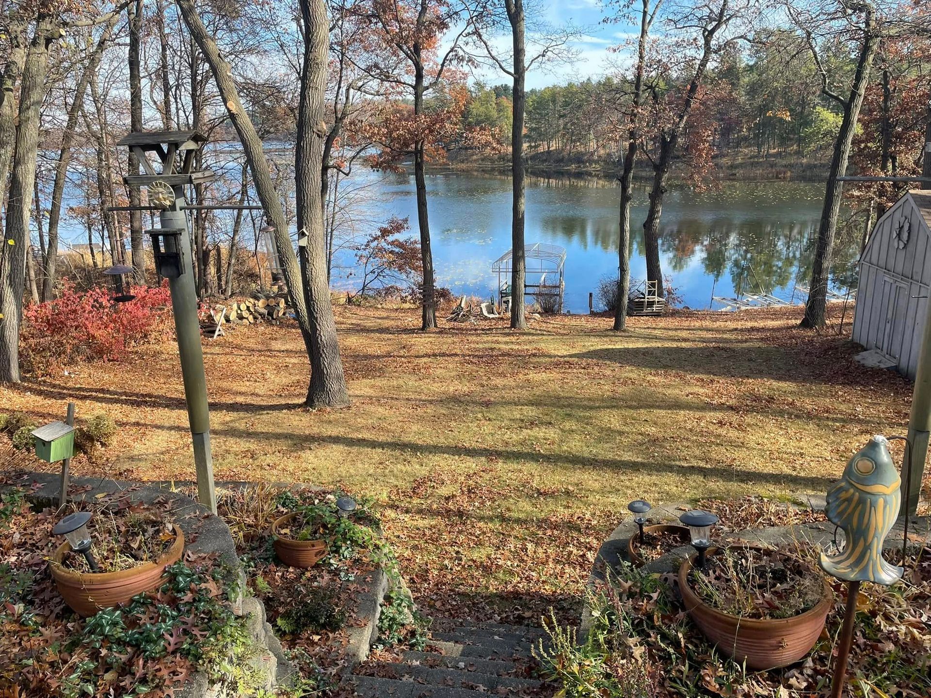 There is a large body of water in the middle of the woods.