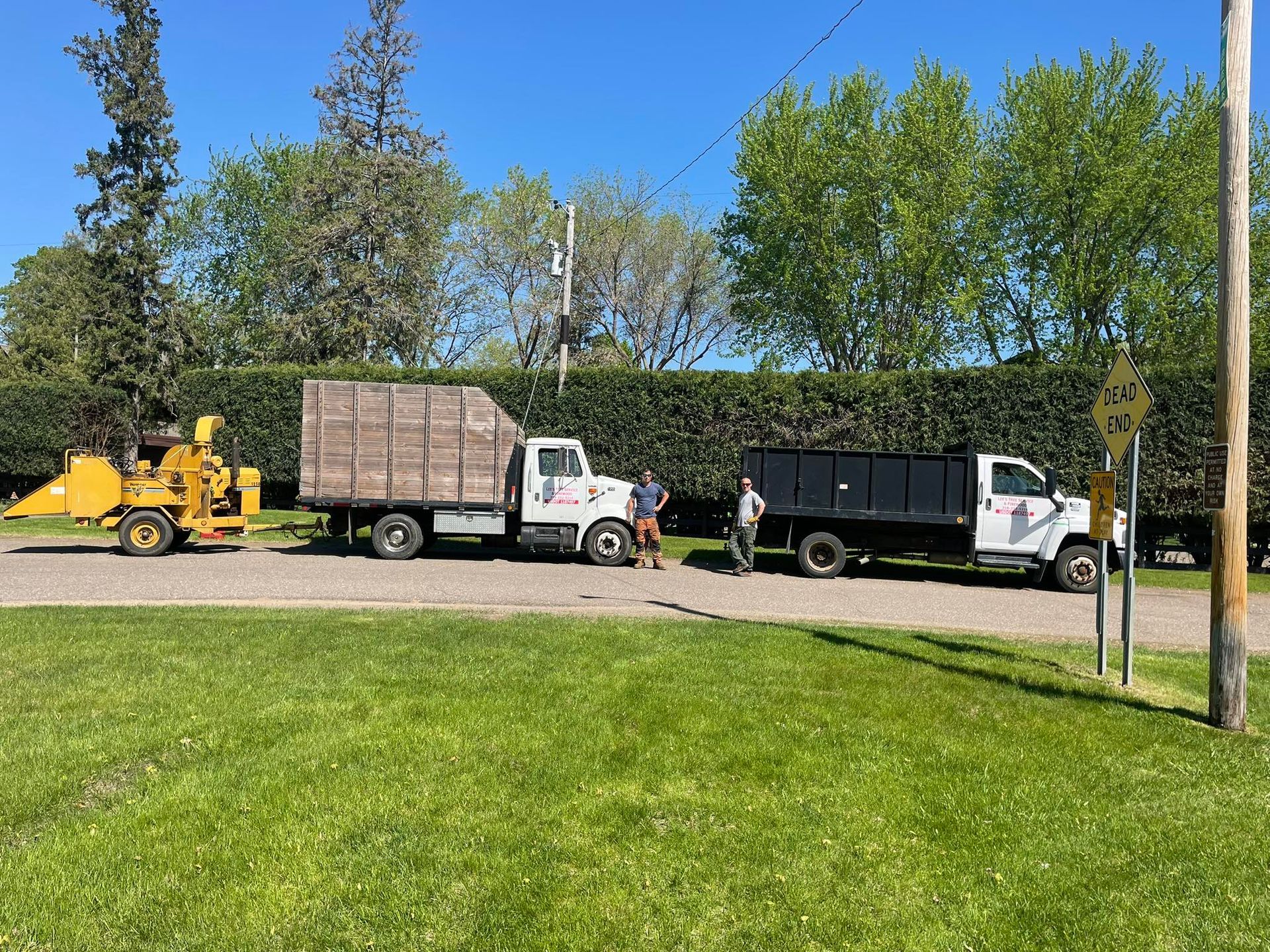 A couple of trucks parked next to each other on the side of the road.