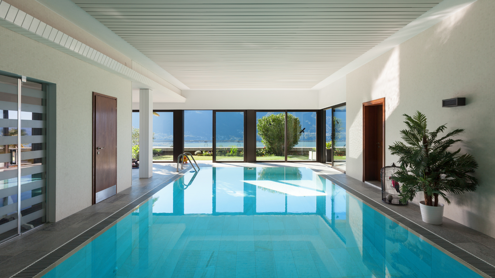 There is a large indoor swimming pool in the middle of the room.