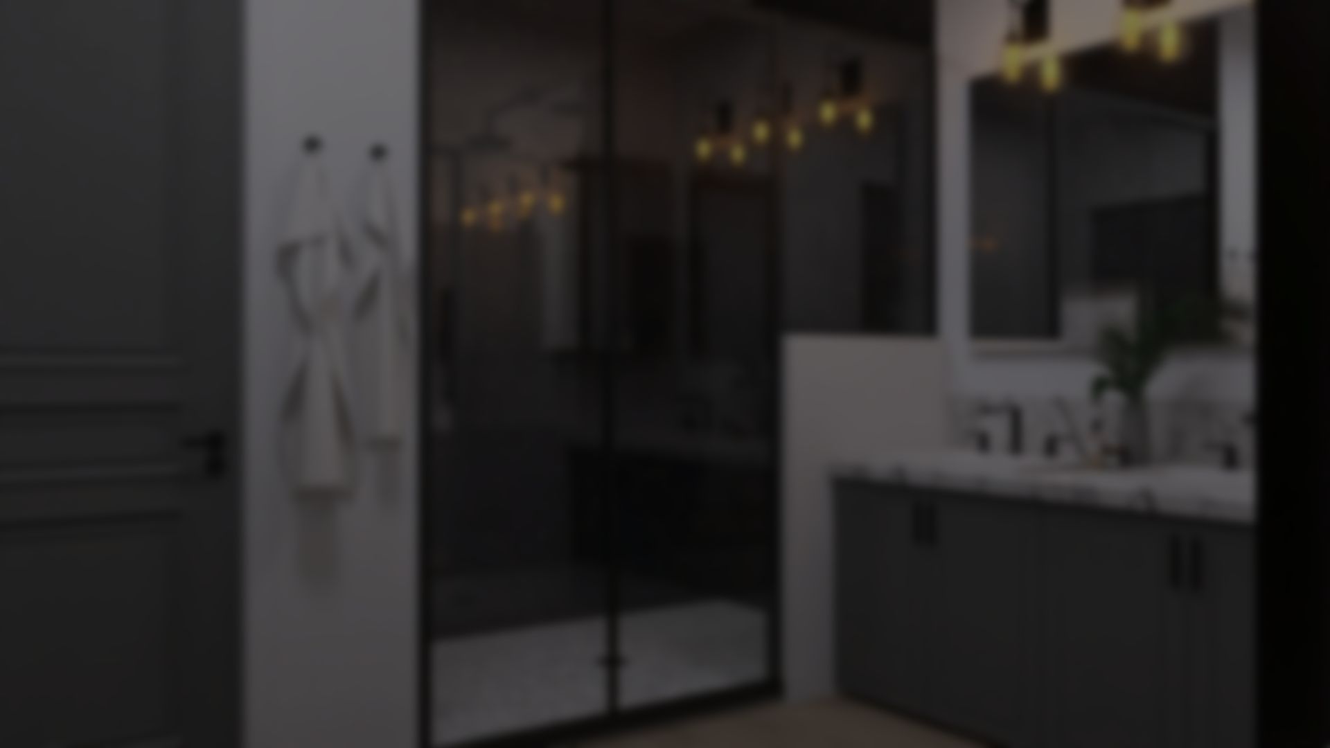 A blurred image of a bathroom with sliding glass doors and a bathrobe hanging on the wall.