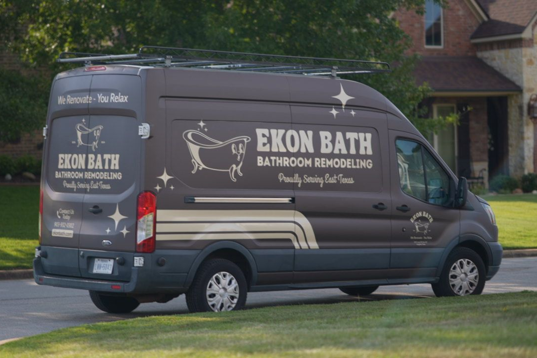 An Ekon Bath bathroom remodeling van parked on a street.
