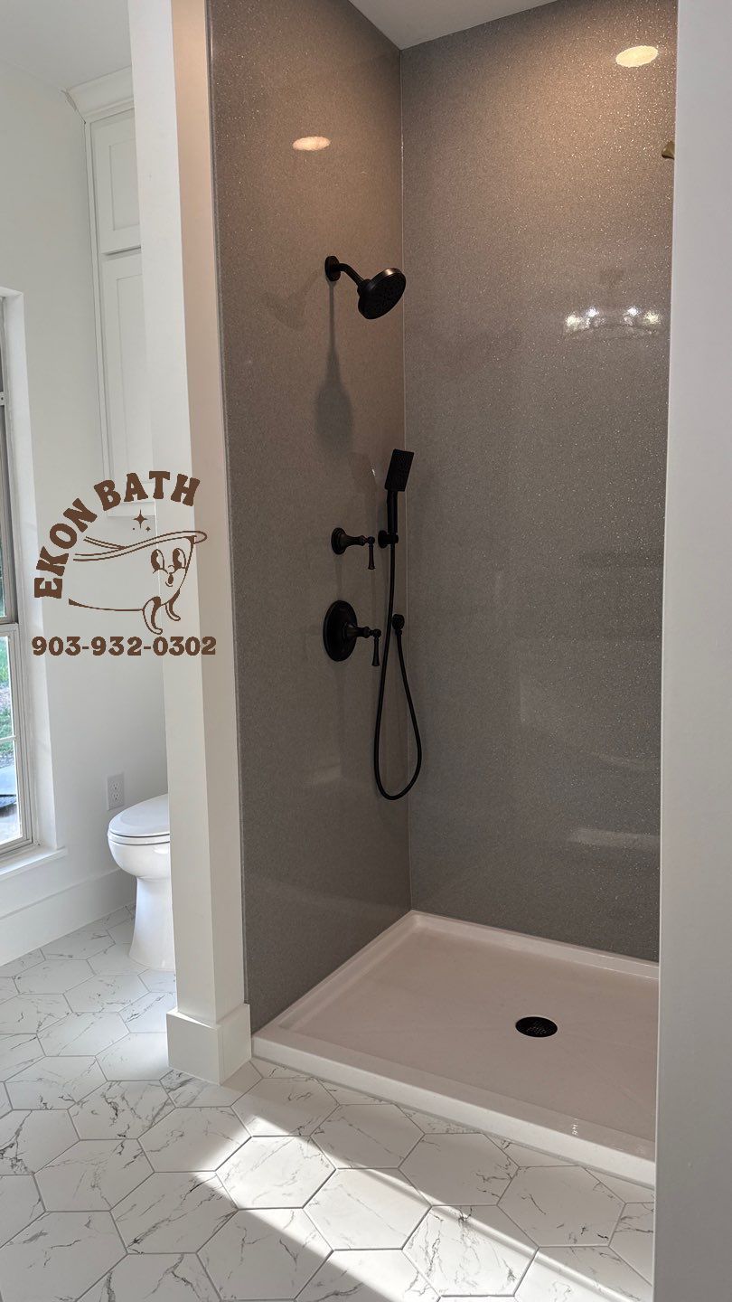 A bathroom with a walk in shower and a toilet.