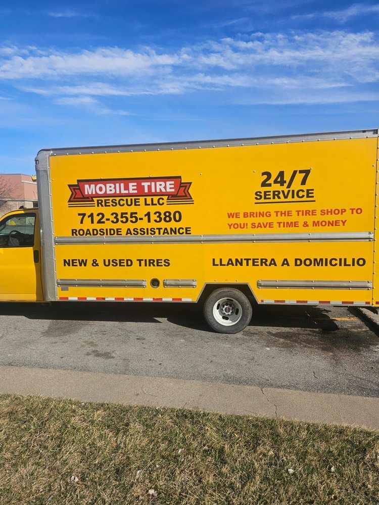 Yellow mobile tire service truck with phone number and 