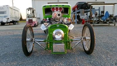 Customizable Vehicle Header Services — Green Car Front View in Bakersfield, CA