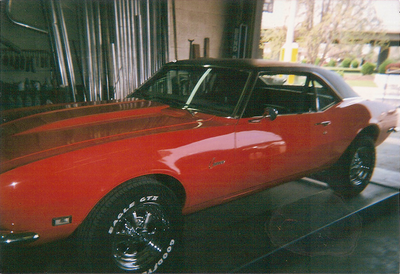 Customizable Exhaust Service — Glossy Red Car Front Side View in Bakersfield, CA