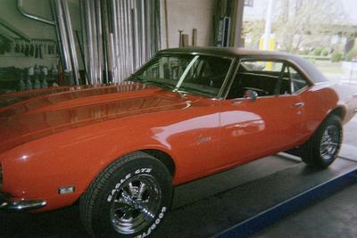 Customizable Muffler Services — Glossy Red Car Front  in Bakersfield, CA