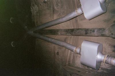 Personalized Exhaust and mufflers Service — Silver Car Muffler Closed-Up in Bakersfield, CA