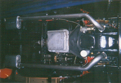 Customized Exhaust — Red Vintage Truck Undercarriage in Bakersfield, CA