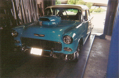Personalized Exhaust Services — Blue and White Colored Car Front Side View in Bakersfield, CA