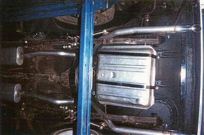 Muffler Services — Muffler of the Red Car Closed-Up in Bakersfield, CA