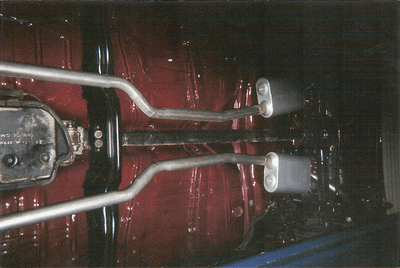 Custom Muffler Services — Dark Brown Car Undercarriage in Bakersfield, CA