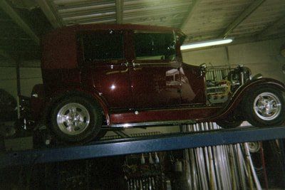 Muffler Services — Red Classic Car Side View in Bakersfield, CA