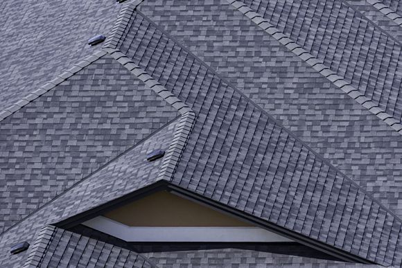 A close up of a roof with a window on it.