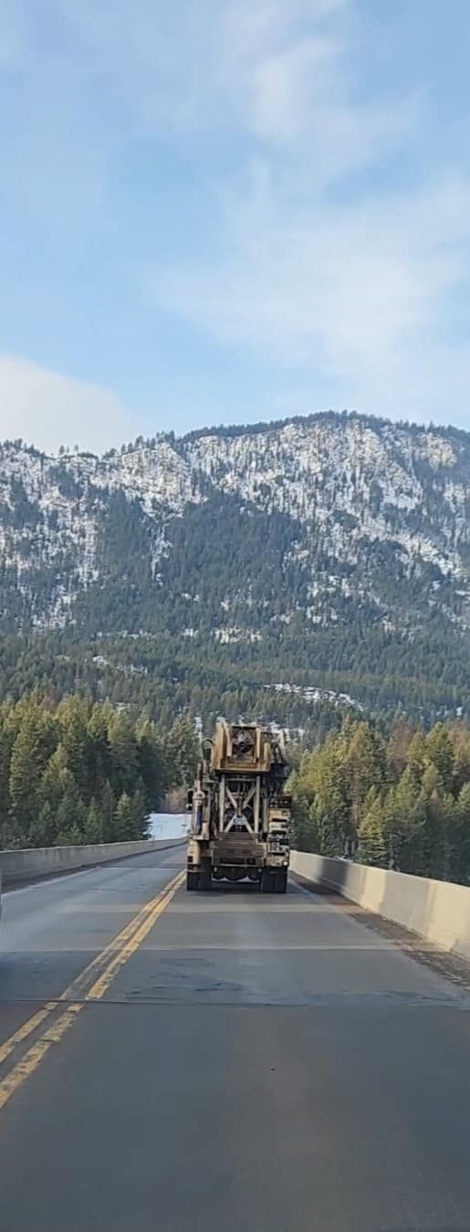 A Truck Is Driving Down A Highway With Mountains | Thompson Falls, MT | North Star Drilling Inc.