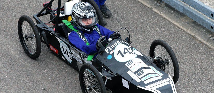 Student driving greenpower car at goodwood