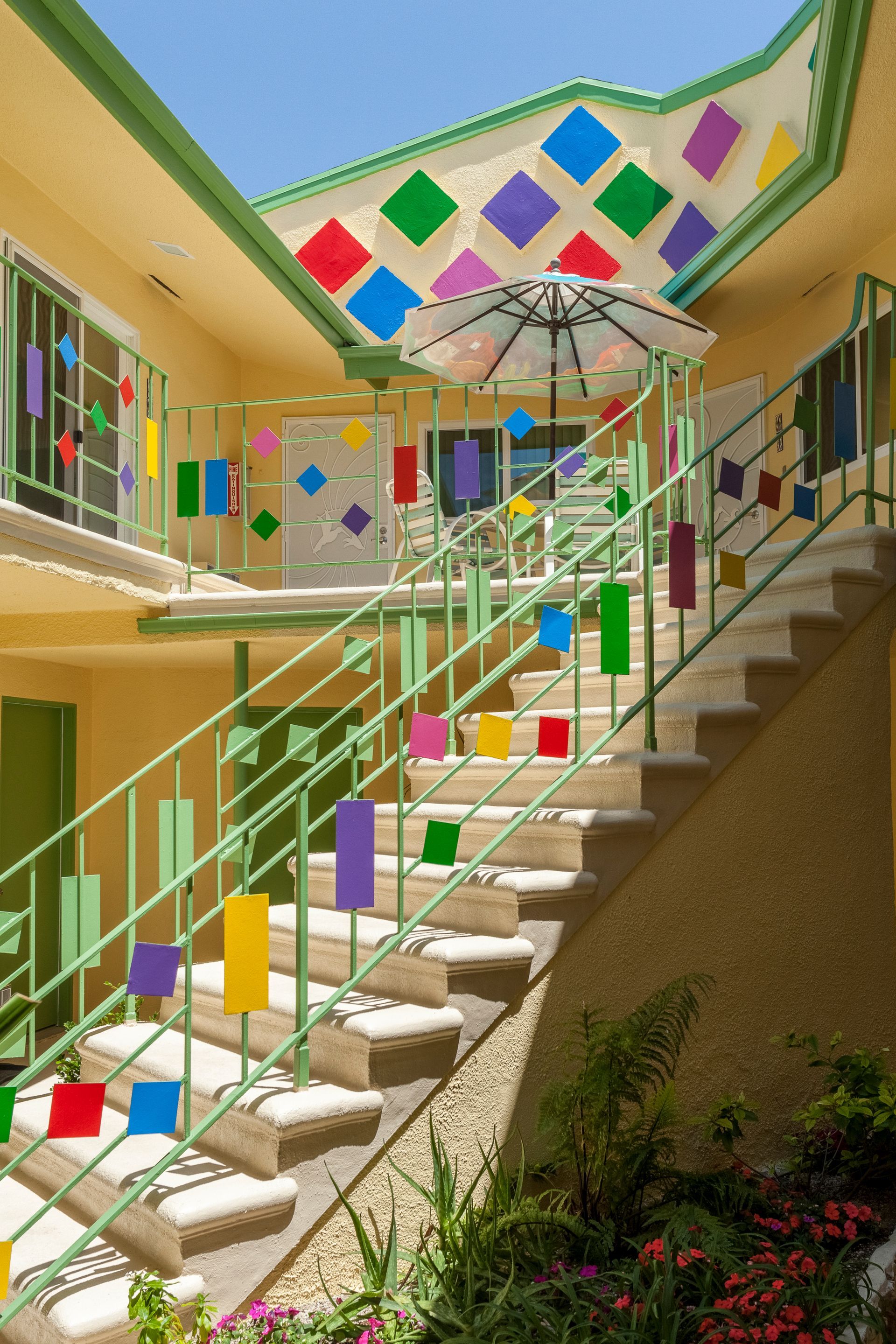 A staircase with colorful squares on the railing