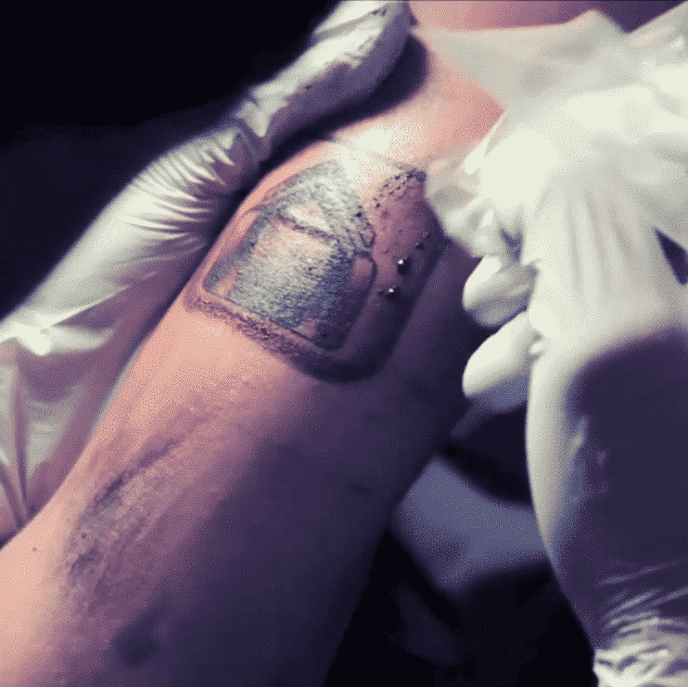 Gloves cleaning fresh tattoo of a door on an arm.