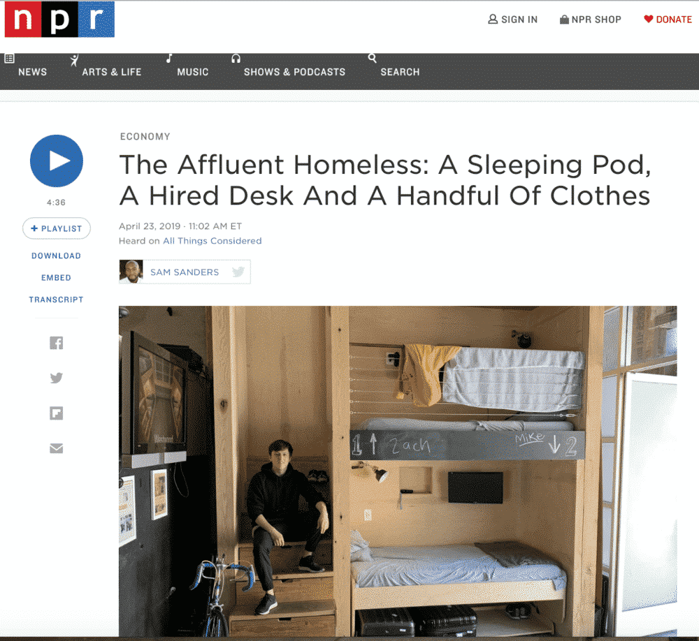 NPR article screenshot: A man sits on steps inside a minimalist sleeping pod with a bicycle and minimal belongings.