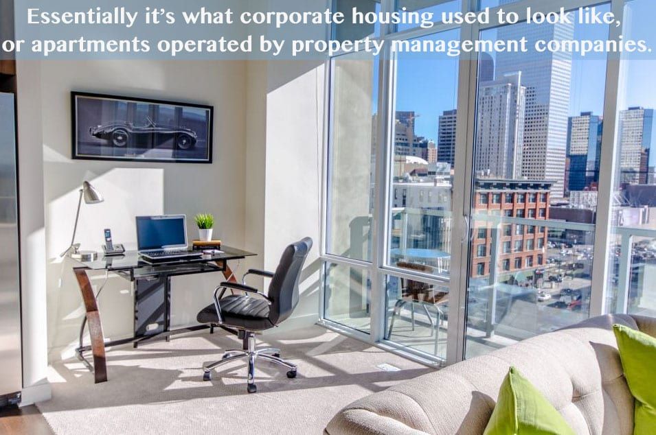 Interior of a modern apartment with city views. A desk and a sofa are visible. Text overlay describes corporate housing.