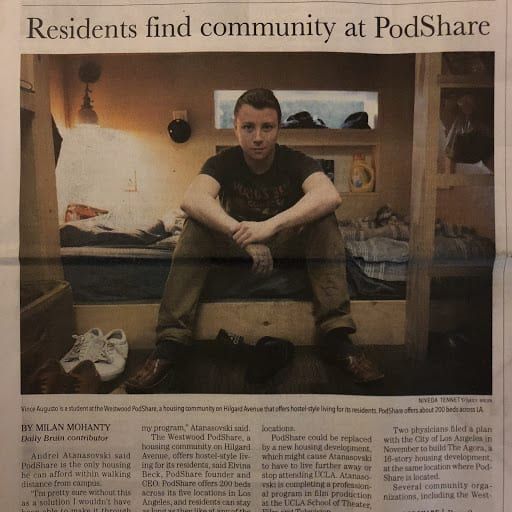 Man sits in a PodShare room. Article about the housing community.