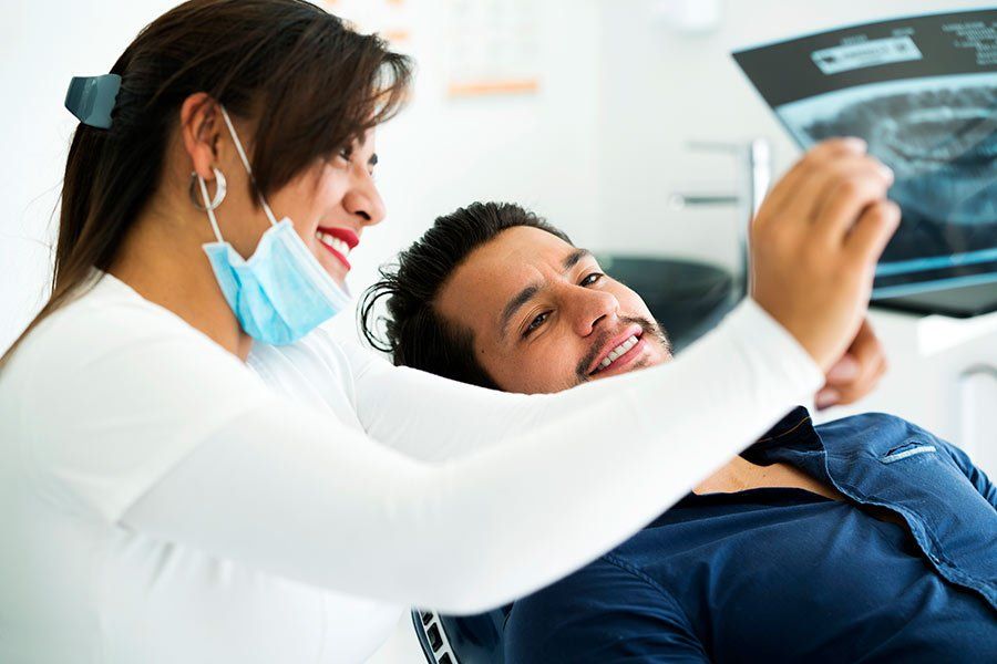Dentist and Patient Checking the Results — Jefferson, LA — Teresita V Hernandez DDS