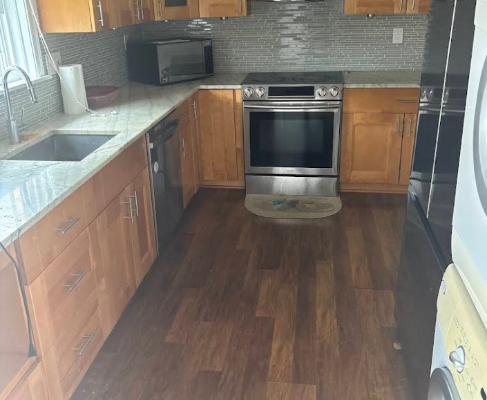 Kitchen with wooden cabinets, stainless steel appliances, and granite countertops.
