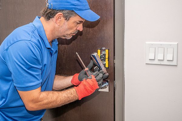 Experienced locksmith performing non-destructive lock repair on a residential door. Experienced locksmith performing non-destructive lock repair on a residential door.