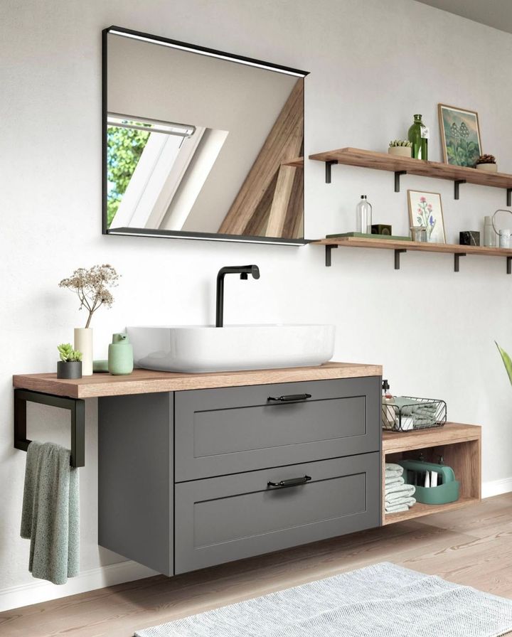 Modern bathroom with a gray vanity, black faucet, rectangular mirror, and wooden shelves.