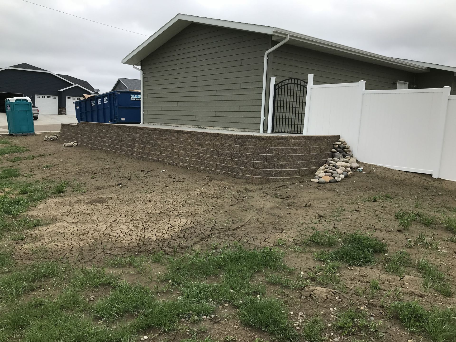 A broken tree trunk in a field. The top of the tree is fallen with foliage, clear blue sky.