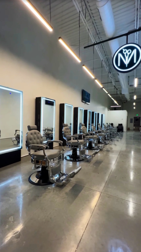 A barber shop with a lot of chairs and mirrors.