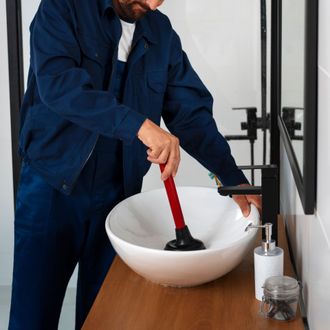 man plunging sink