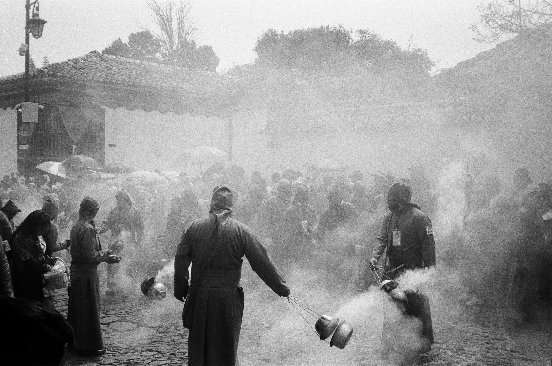 A black and white photo of a group of people standing in a crowd.