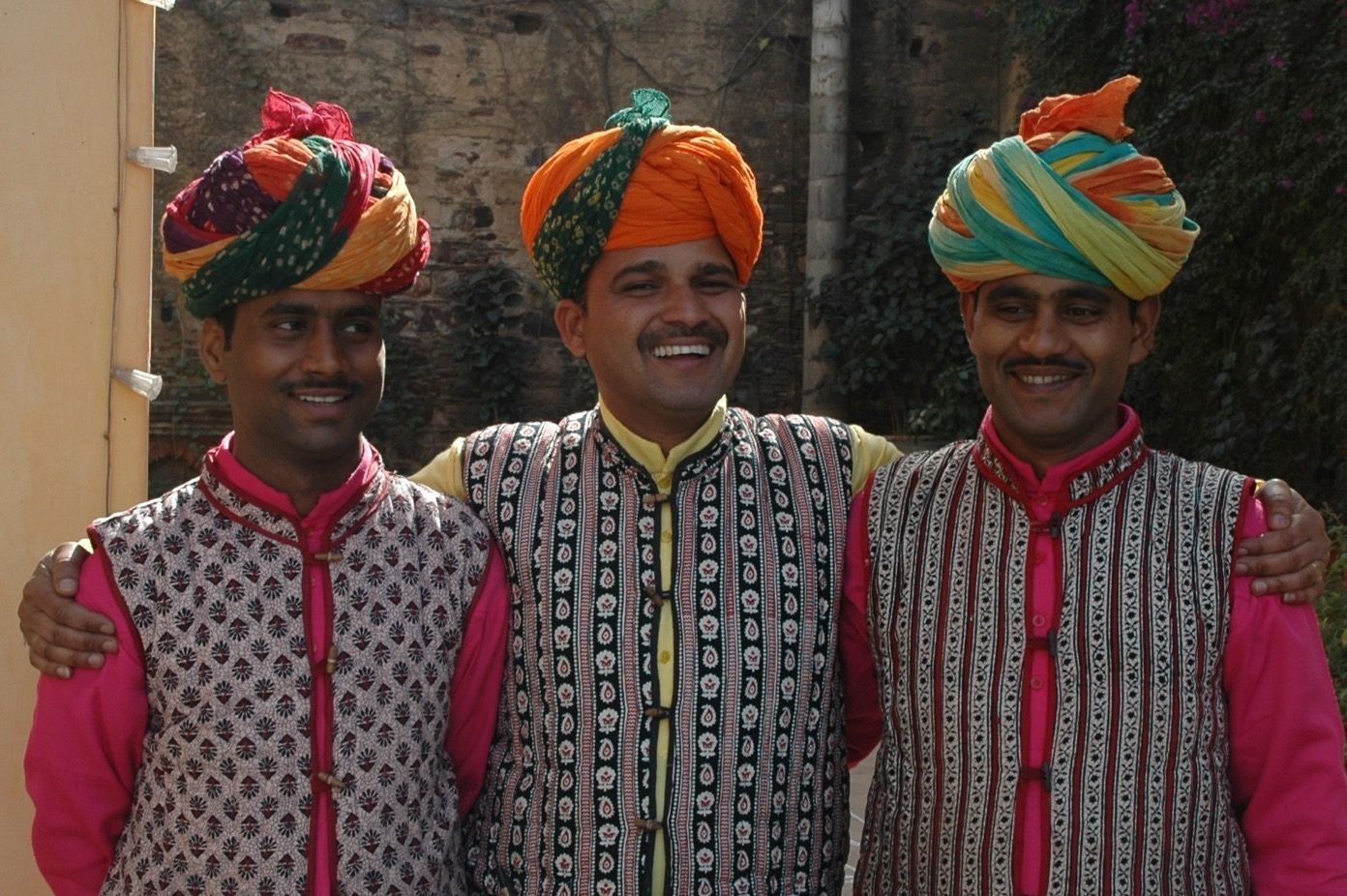 Three men wearing turbans are posing for a picture