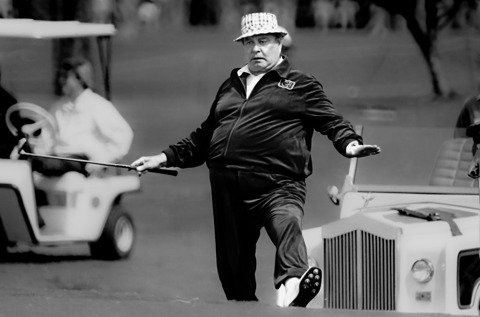 A black and white photo of a man playing golf