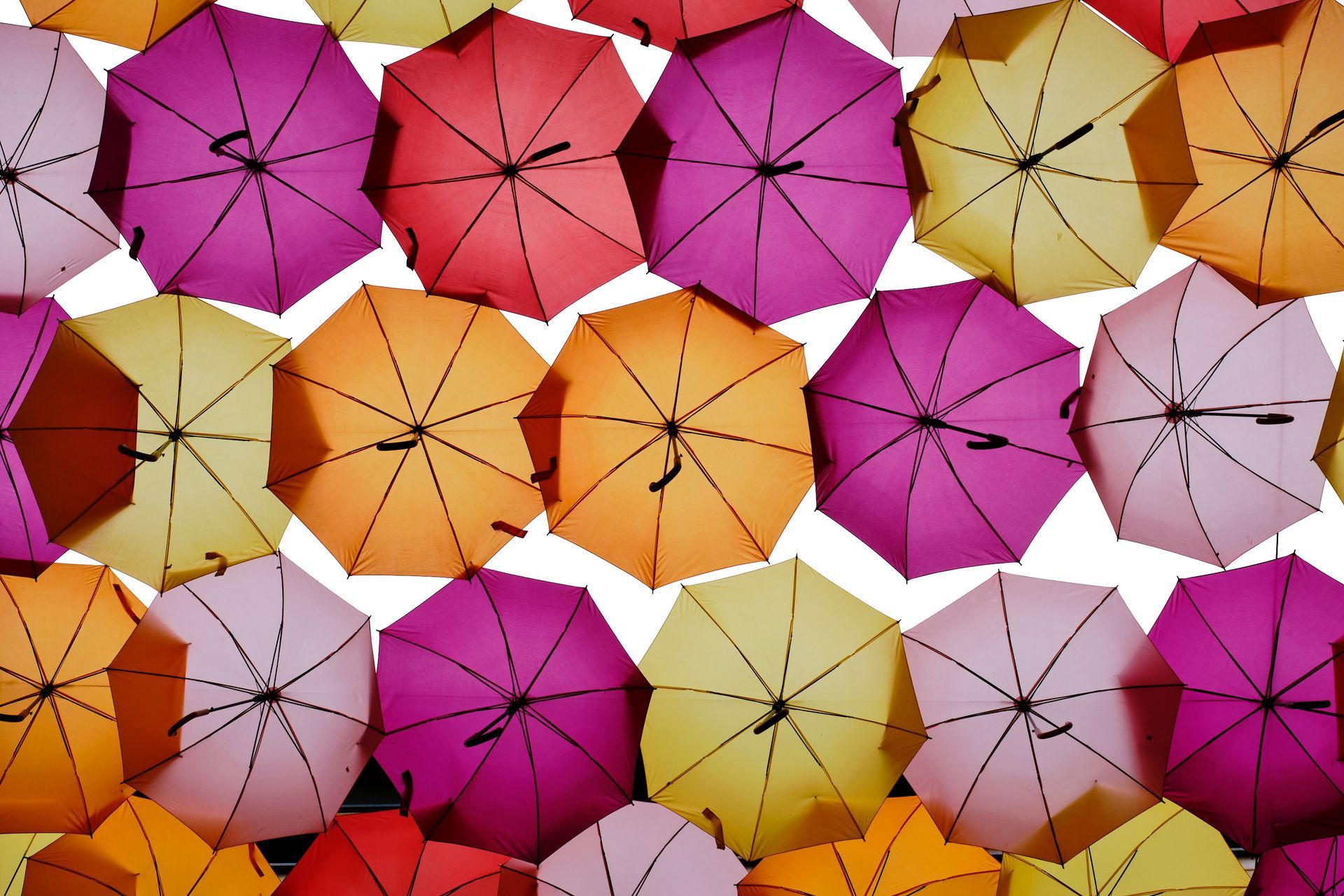A bunch of colorful umbrellas on a white background