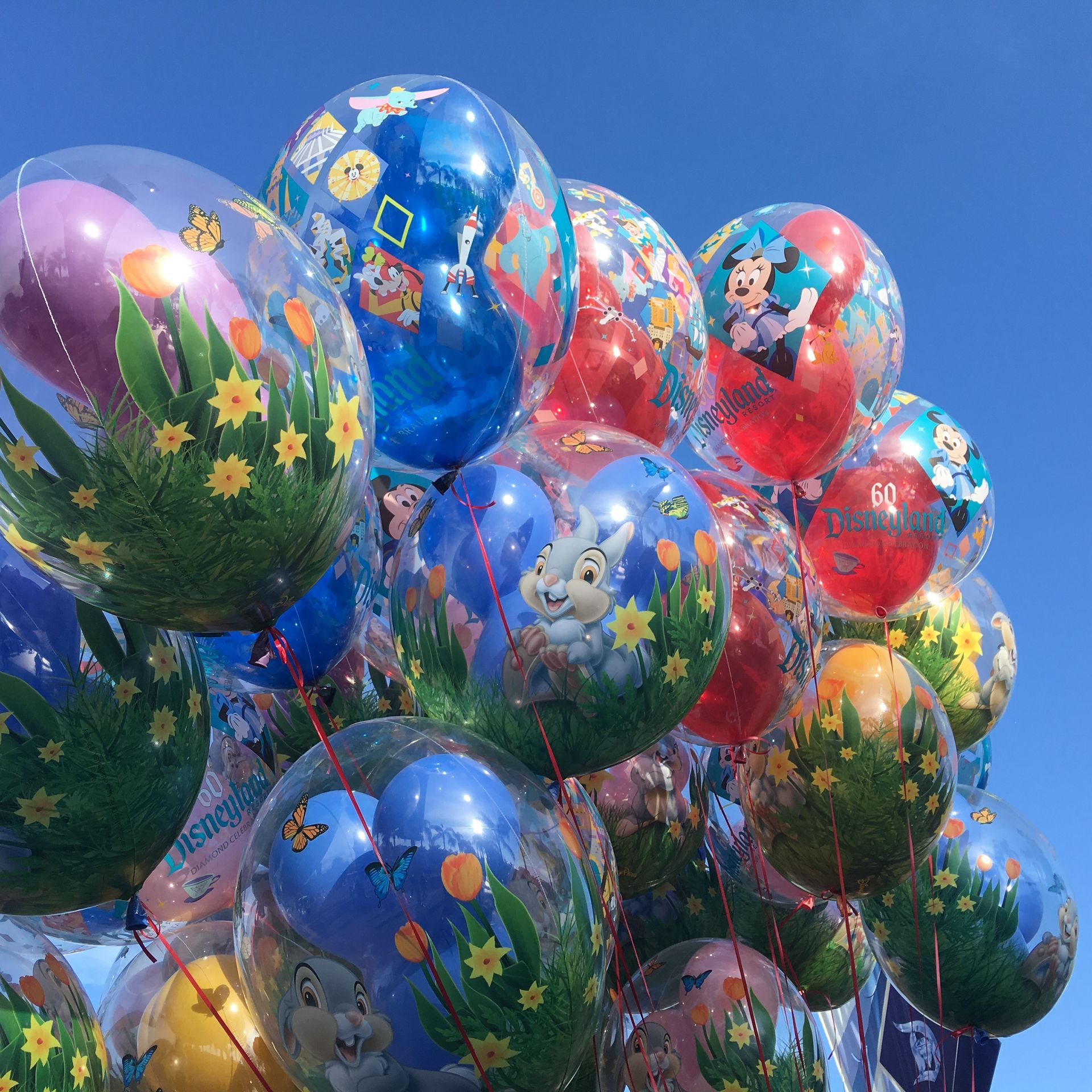 A bunch of balloons with one that says 60 on it